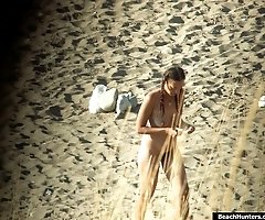 Heated up babes get filmed naked by beach hunters
