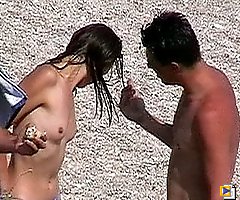 Tight nudist hottie caught on cam on a beach