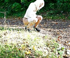 Voyeur shots of a blonde teeny pissing outdoors